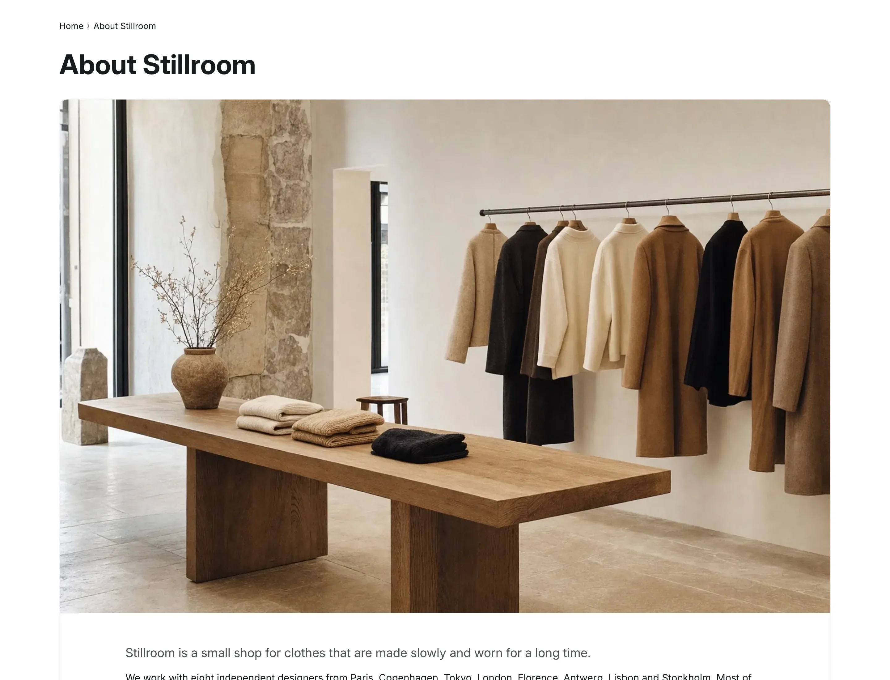 About page in the Card layout: the page title, a wide photo of a clothing store that fills the top of a bordered card, and the start of the page text inside the card.